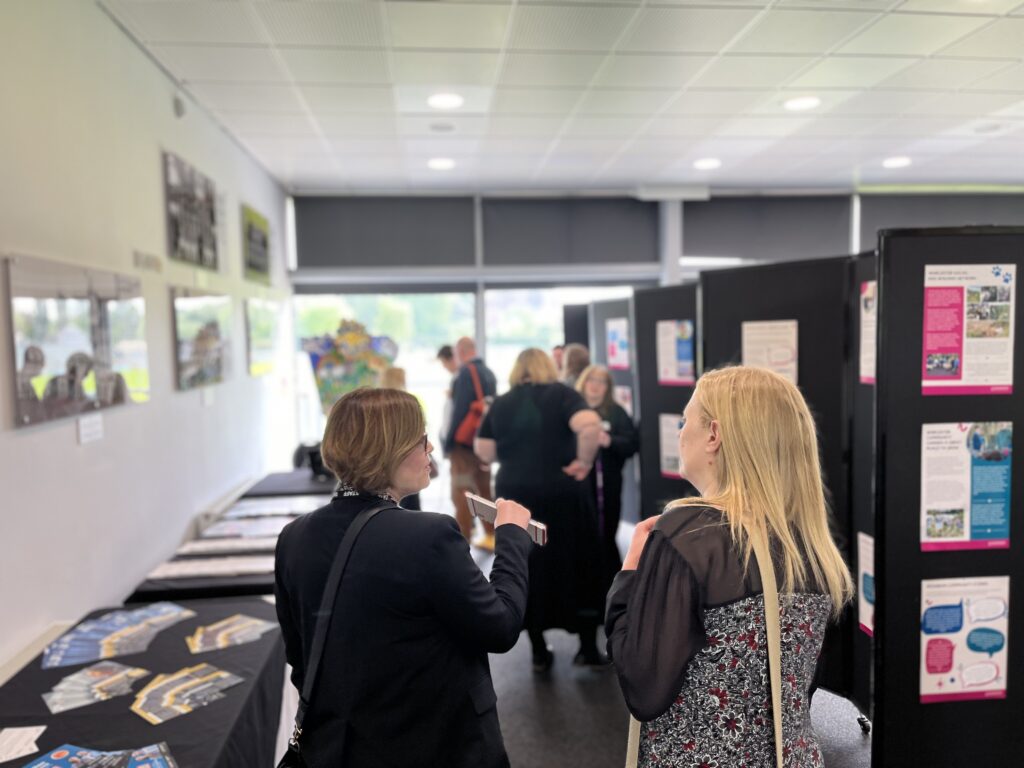 Two people looking at a poster display