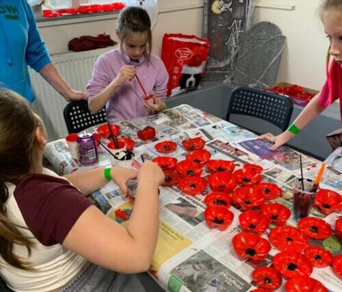 Young people decorating poppies