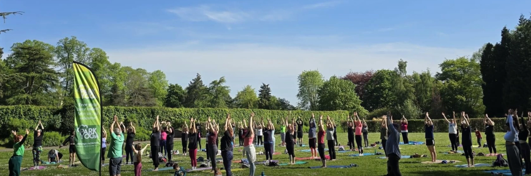 Park yoga with quote about positive outcomes for wellbeing