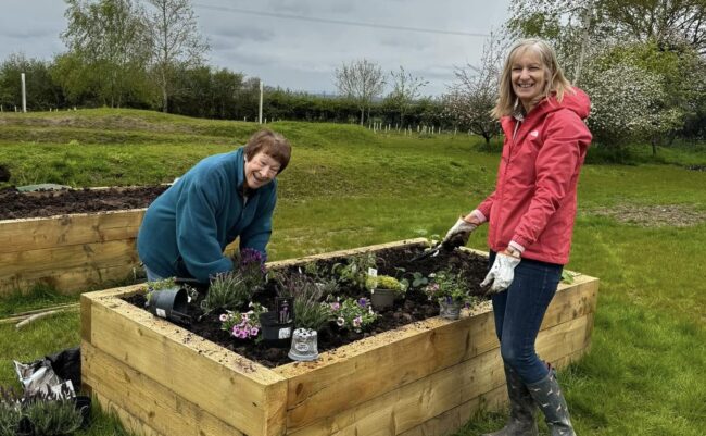 Two women enjoying the new community garden
