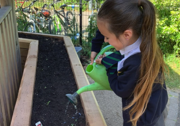 School girl watering plants