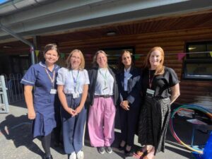 5 women standing outside a Family Hub smiling